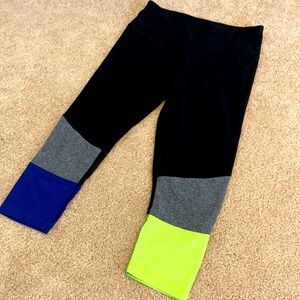 Black workout leggings with neon yellow and blue bottom detail